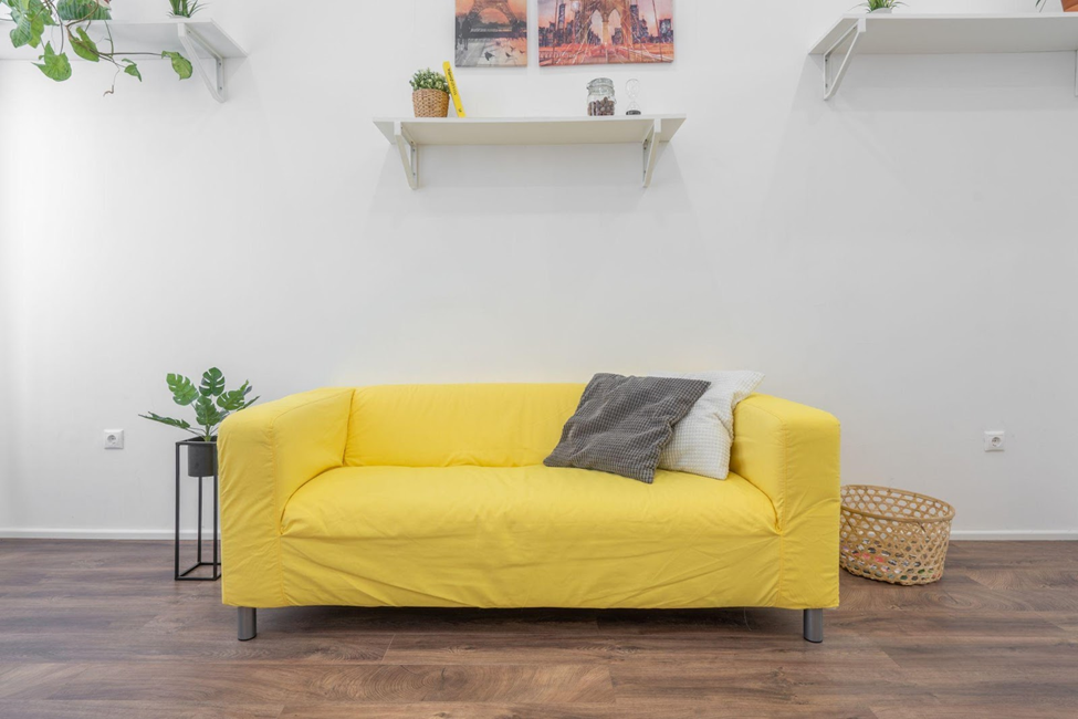 Yellow couch on vinyl plank flooring
