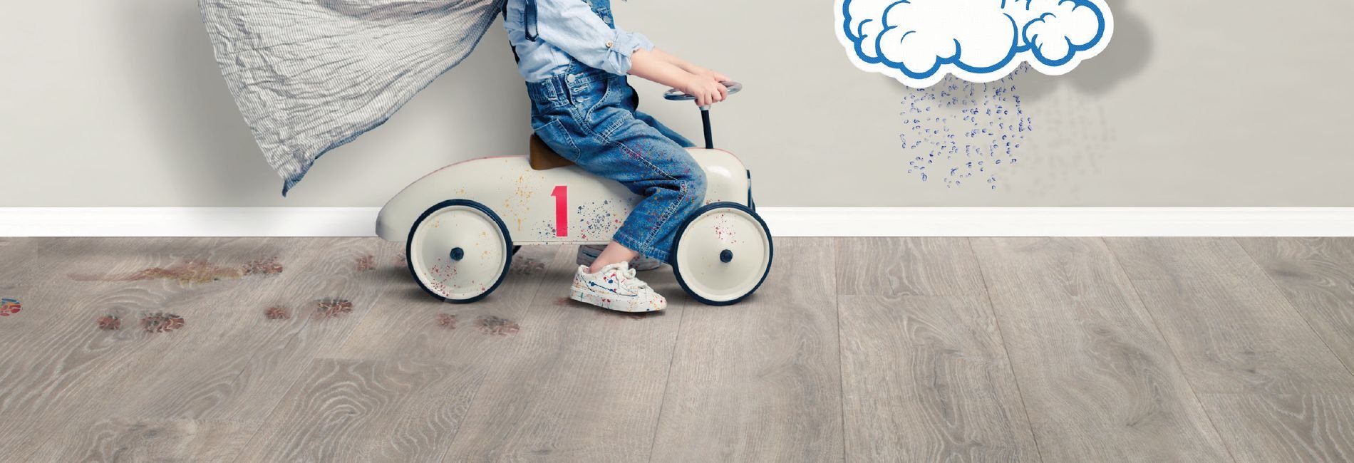 Toddler playing on Revwood resistance hardwood flooring.